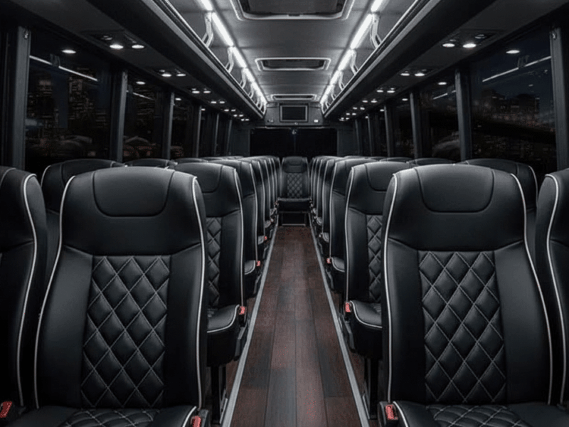 Gemini_Generated_Image_v0lc4uv0lc4uv0lc The modern interior of a 36-passenger mini coach bus with large panoramic windows.